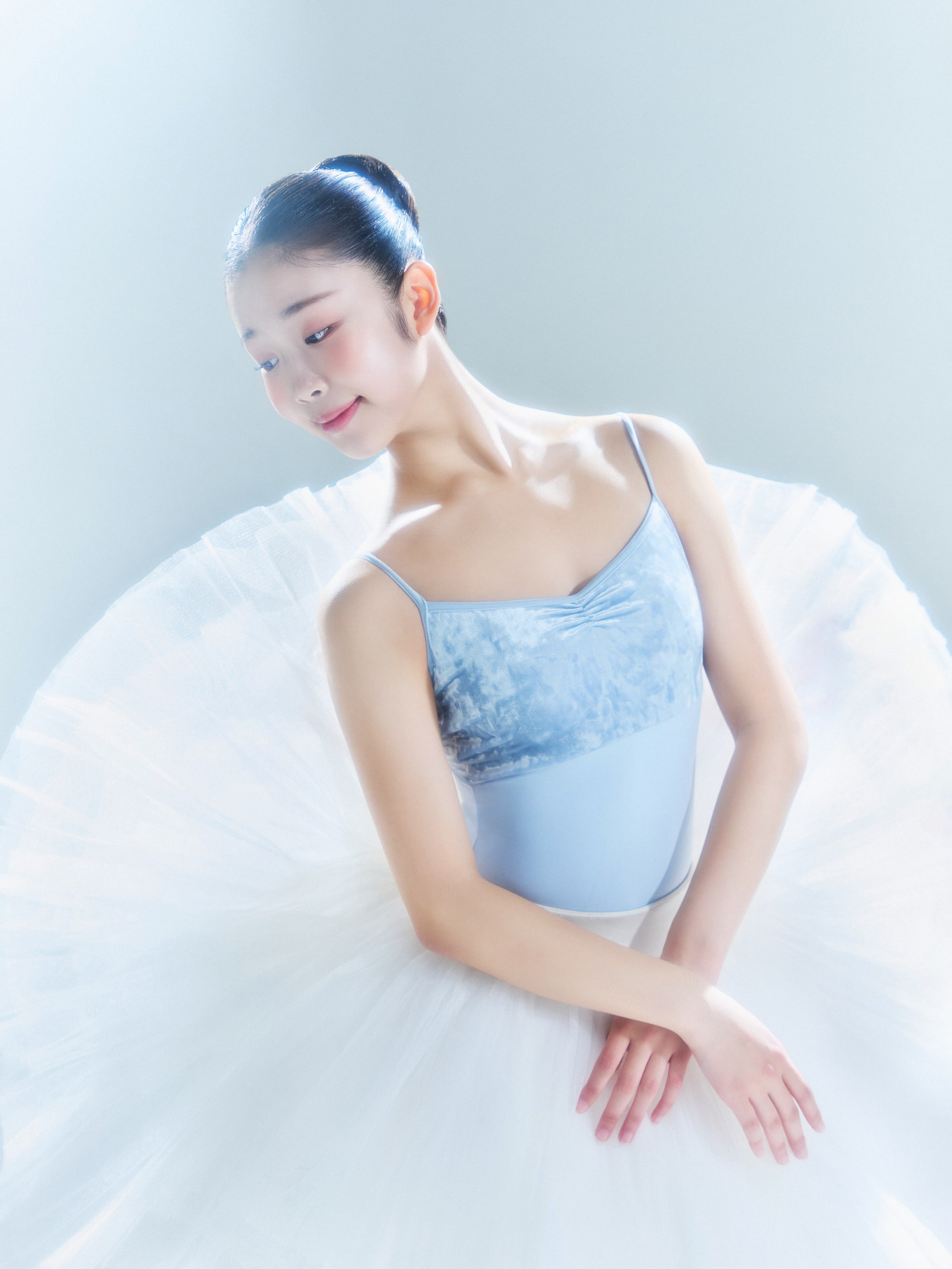Close portrait in a white tutu, arms crossed