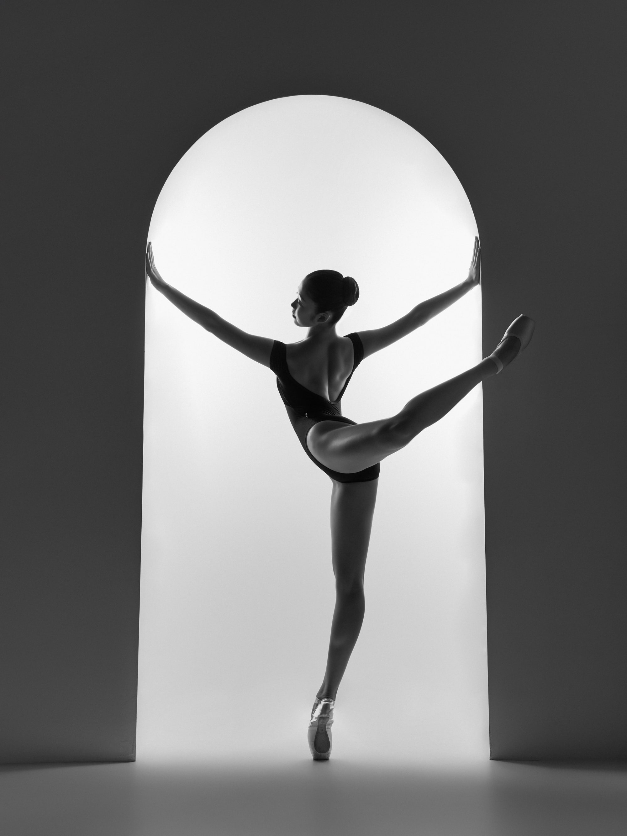 Silhouette in an arched doorway, arabesque
